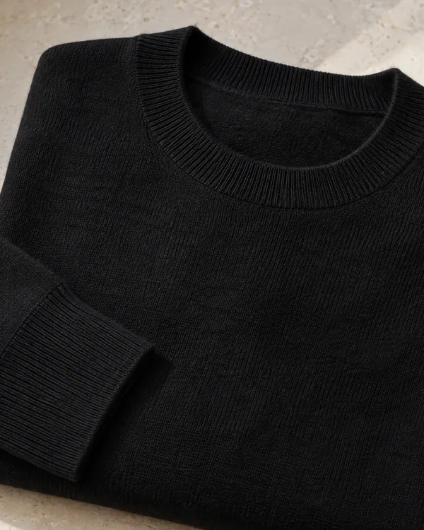 Close view of the neckline of the black merino crew